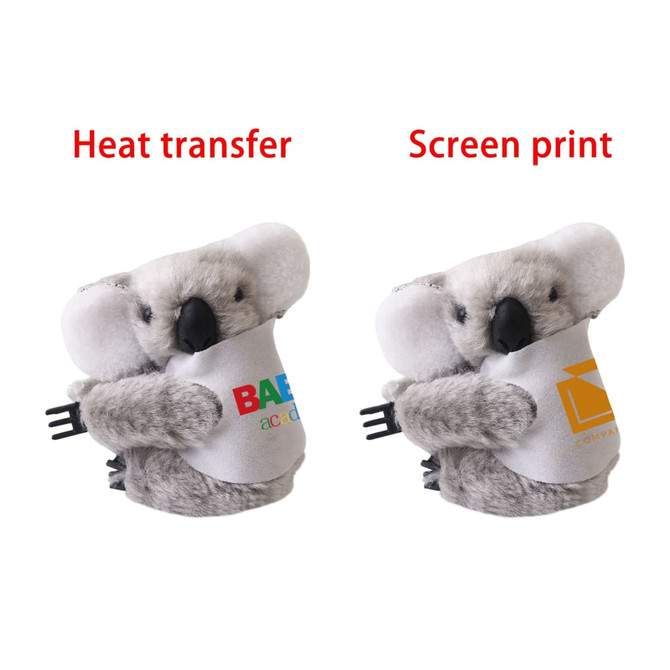 A grey koala plush toy with a holdable design, featuring two printed designs on its body and a logo.