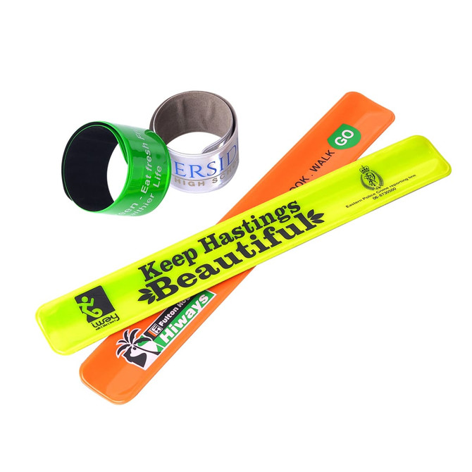 Four slap bands in various colours: neon yellow, orange, green, and black, with a logo on one.