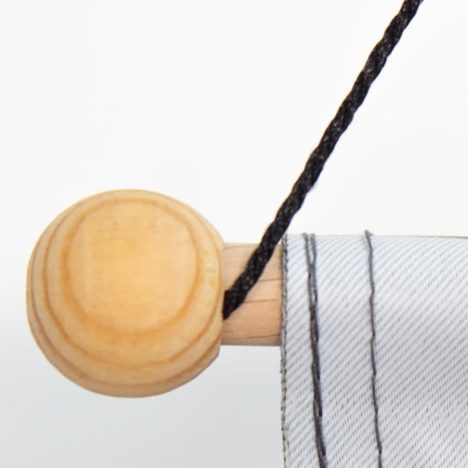 A hanging banner with a wooden rod and black cord, featuring a grey fabric section.