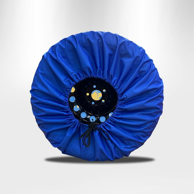 A blue spare tyre cover with a black inner section and a gathered edge, featuring a circular shape.