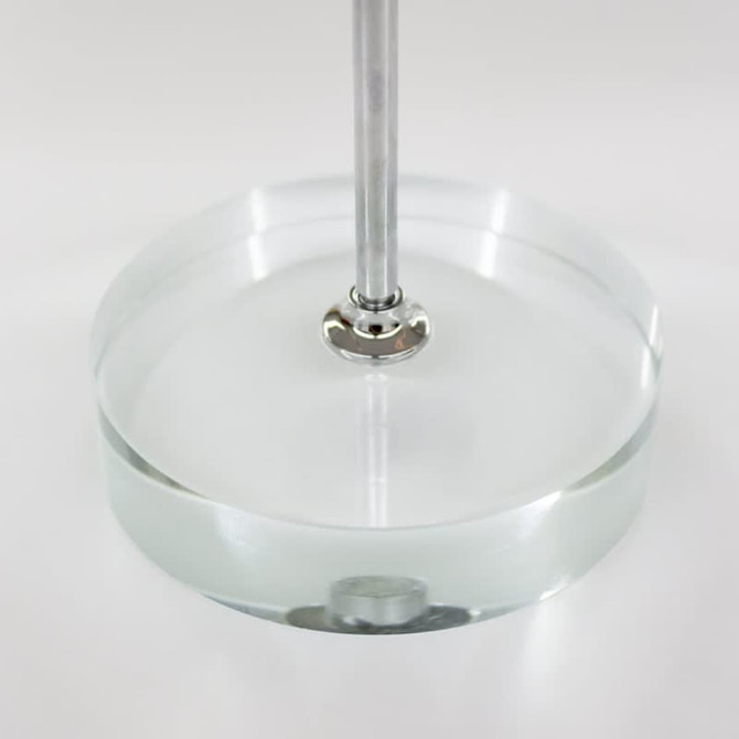 A clear circular base with a metal rod, designed for displaying desk flags.