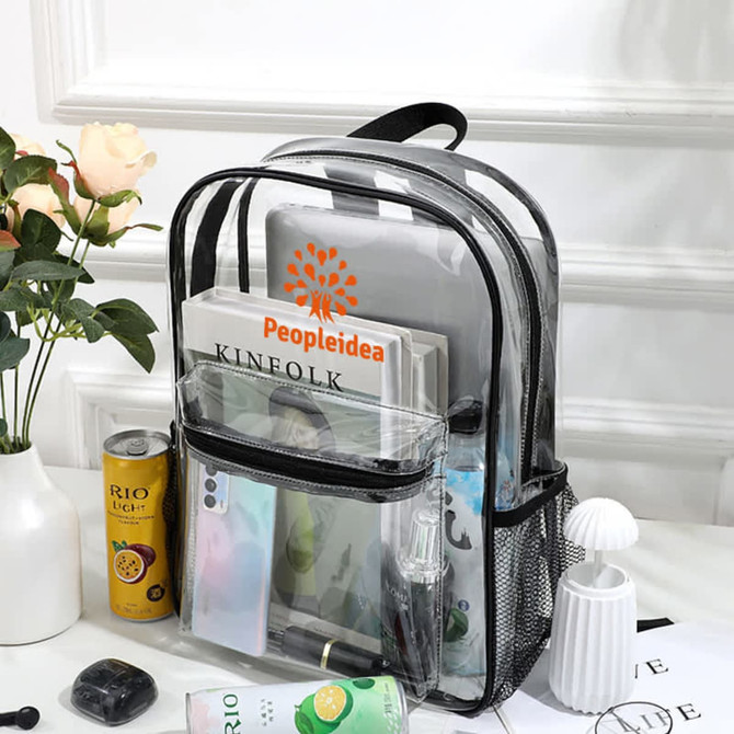 A transparent backpack in black with various items inside, including a laptop, books, and stationery.
