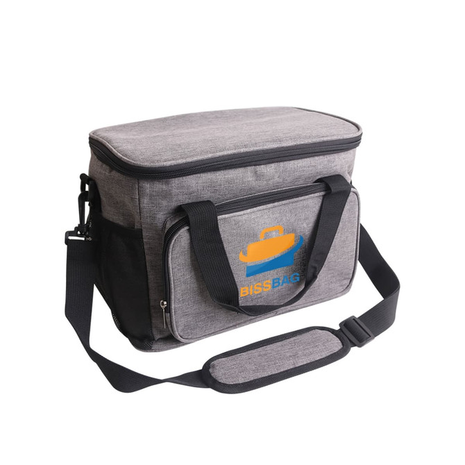 A grey cooler bag with a removable shoulder strap, featuring a front zip pocket and a logo.