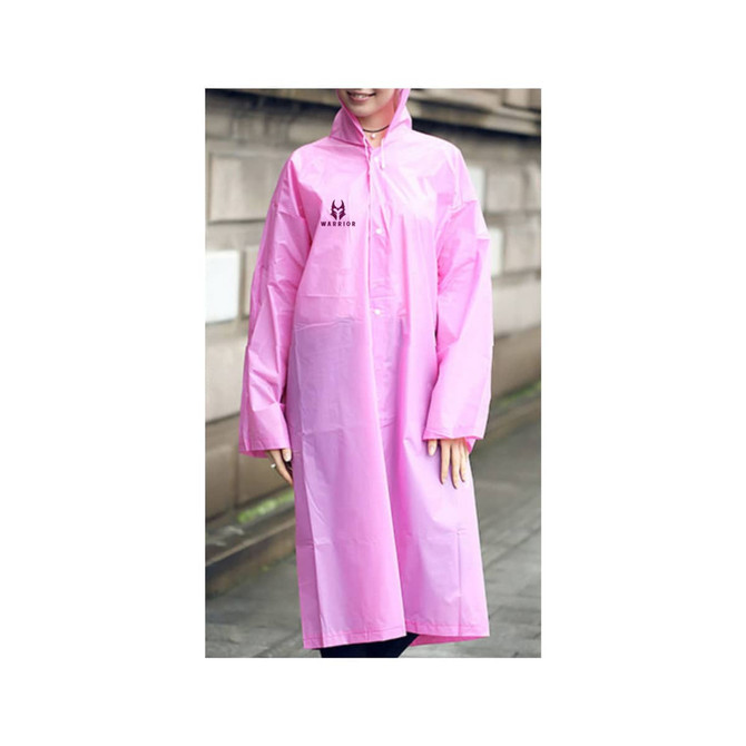 A pink reusable PEVA raincoat featuring a logo, worn by a person in a casual outdoor setting.