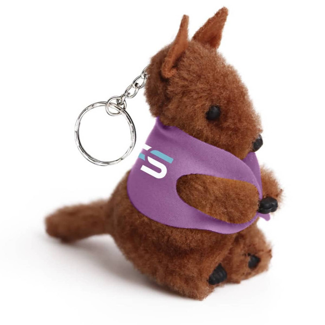 A brown plush kangaroo toy with a keyring, wearing a purple vest, featuring a logo on it.