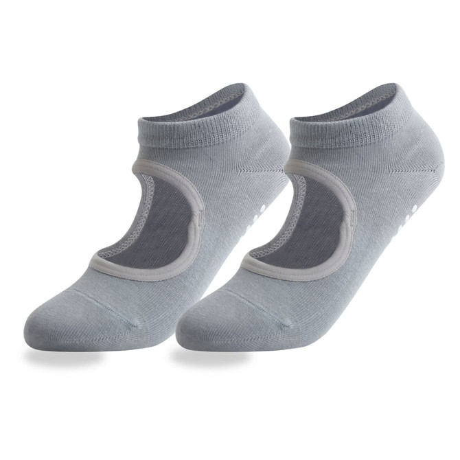A pair of light grey open top yoga socks featuring a logo and non-slip grip on the sole.