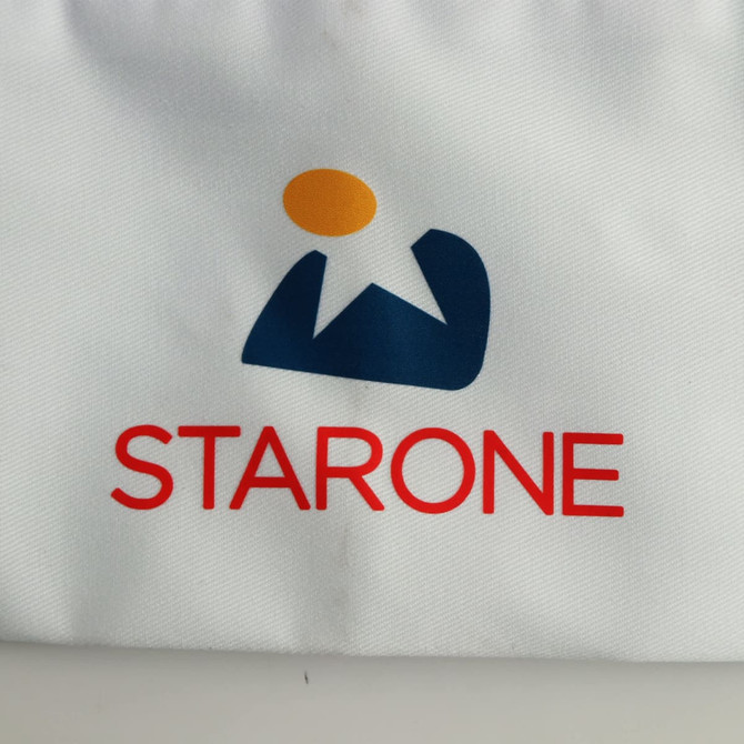 A white chef hat featuring a logo with blue and orange elements, alongside the word "STARONE" in red.