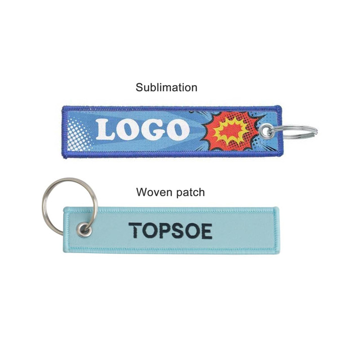 Two woven key tags in blue and light blue, each with a ring and a logo or brand name on them.