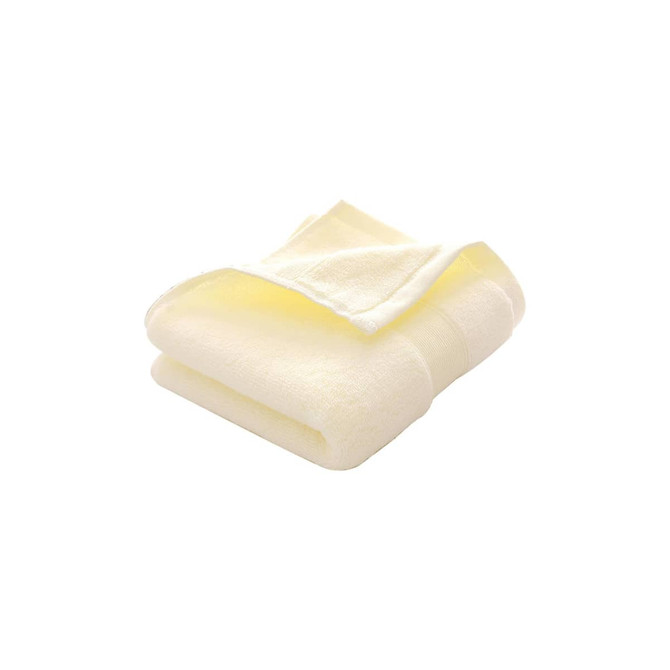 A folded embroidered cotton hand towel in soft yellow, featuring a subtle texture and a logo.