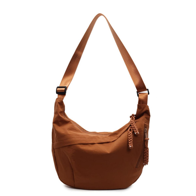 A brown Dumpling Crossbody Bag with a stylish shoulder strap and a decorative zipper detail. Features a brand logo.