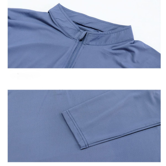 A polyester spandex jacket in blue, featuring a stand-up collar and quarter-zip design, with long sleeves and a logo.