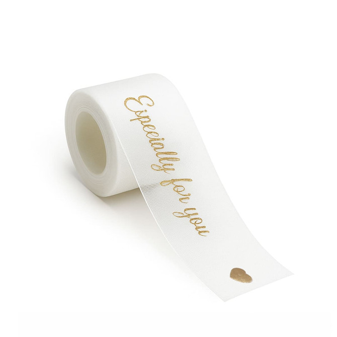 A roll of white organza ribbon with a gold printed message, featuring a small heart design.
