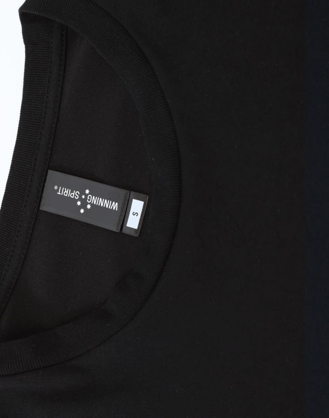 A black men's long-sleeve tee shirt with a rounded neckline and a tag showing sizing information.