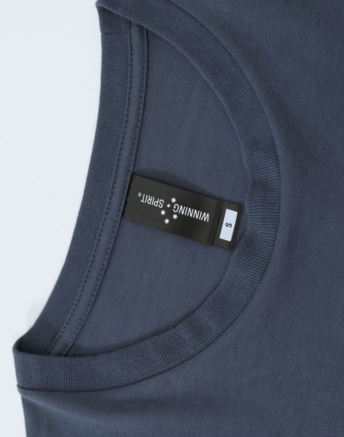 A navy blue long-sleeve tee shirt with a round neckline and a label inside the collar.