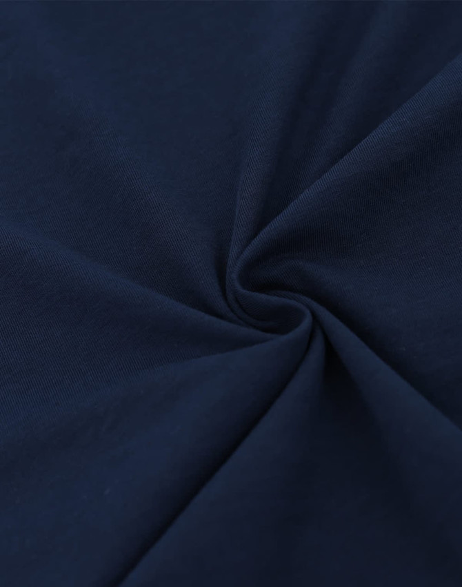 A close-up of navy blue cotton fabric, showcasing a smooth and soft texture with a spiral pattern.
