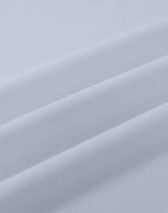 A close-up view of white cotton fabric, showcasing its smooth texture and soft folds.