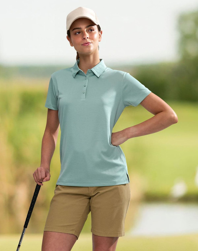 A teal ladies' sustainable jacquard knit short sleeve polo with a collar and side split. It has a logo on it.