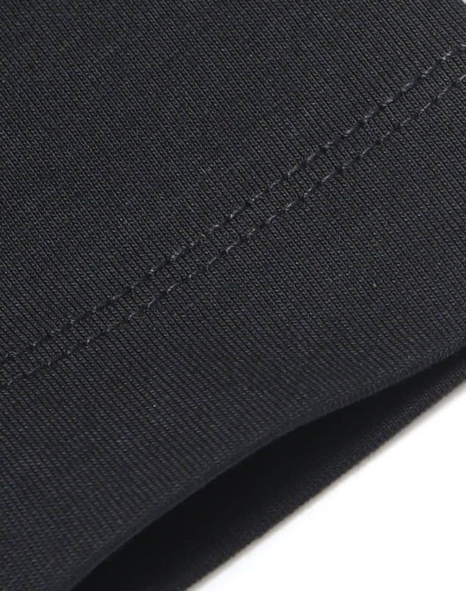 A close-up of a black premium cotton tee shirt, showcasing its smooth fabric and stitching details.