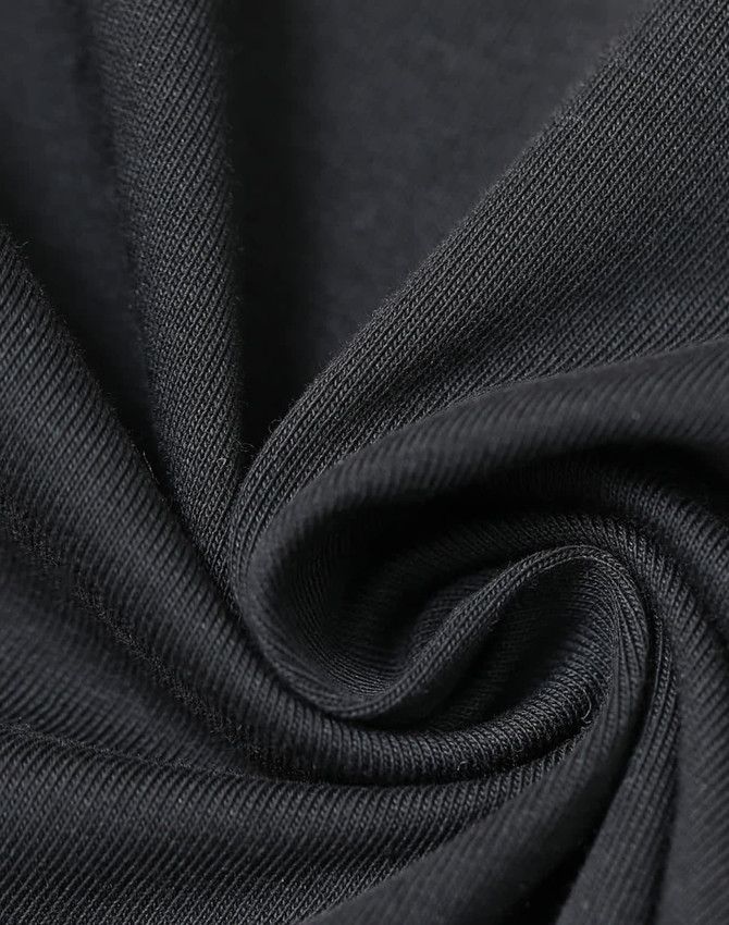 A close-up of black premium cotton fabric, showing its soft texture and fine weave. The fabric has a slight sheen.