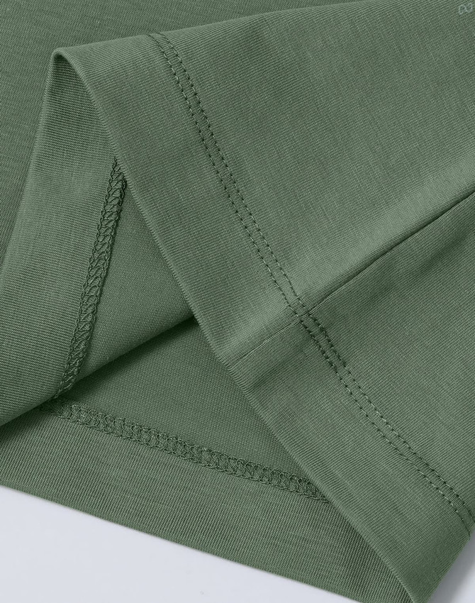 A green ladies' premium cotton short-sleeve tee shirt, featuring neat stitching at the sleeves. There is a logo present.