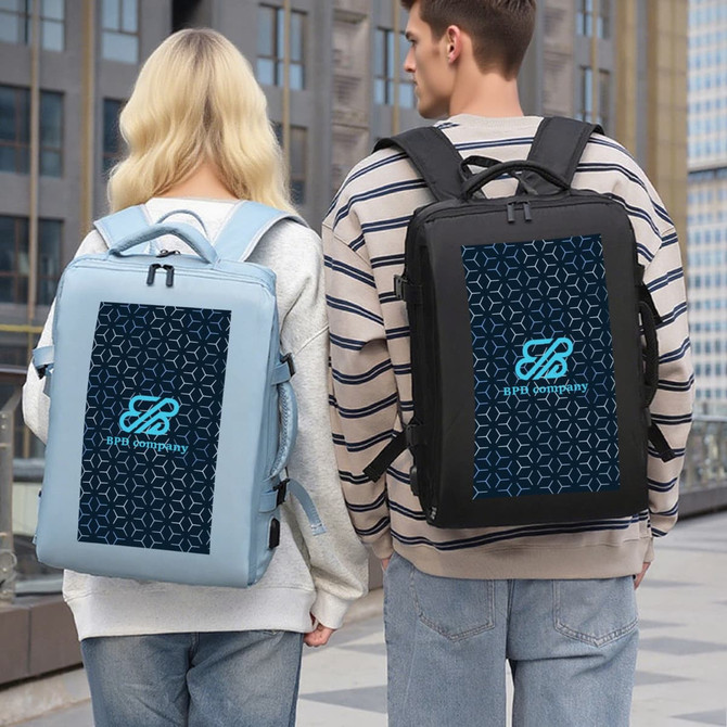 A light blue and a black travel backpack with a logo, displayed from the back against a cityscape backdrop.