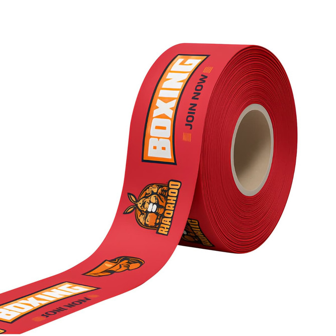 A roll of red promotional ribbon featuring boxing-themed graphics and a logo.