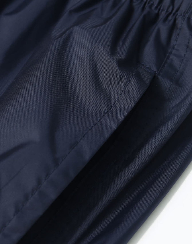 Lightweight nylon waterproof rain pants in navy, featuring an elastic waistband and a smooth texture.