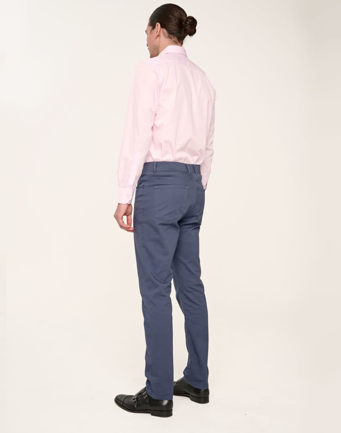 Men's flexi chino pants in navy, paired with a light pink shirt. The back view showcases the fit and design.