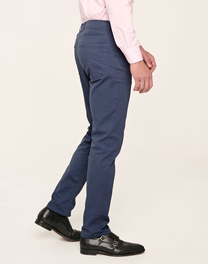 Men's flexi chino pants in navy, styled with a slim fit and back pocket details, featuring a logo.
