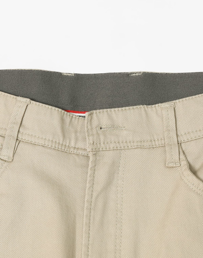 Men's flexi chino pants in a light beige colour, featuring a waistband and pockets, with a logo present.