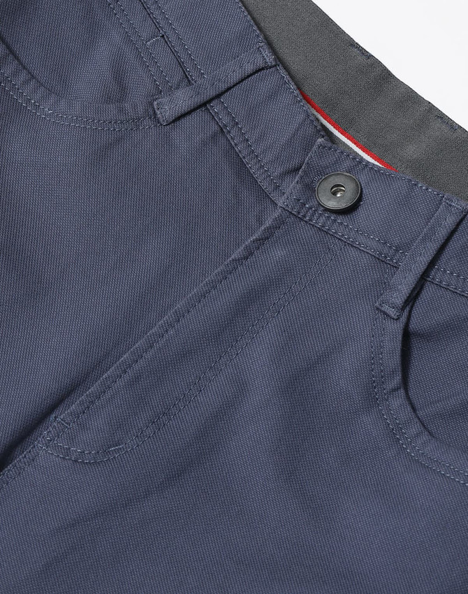 A pair of men's flexi chino pants in navy, featuring a button closure and pockets, with branding visible.