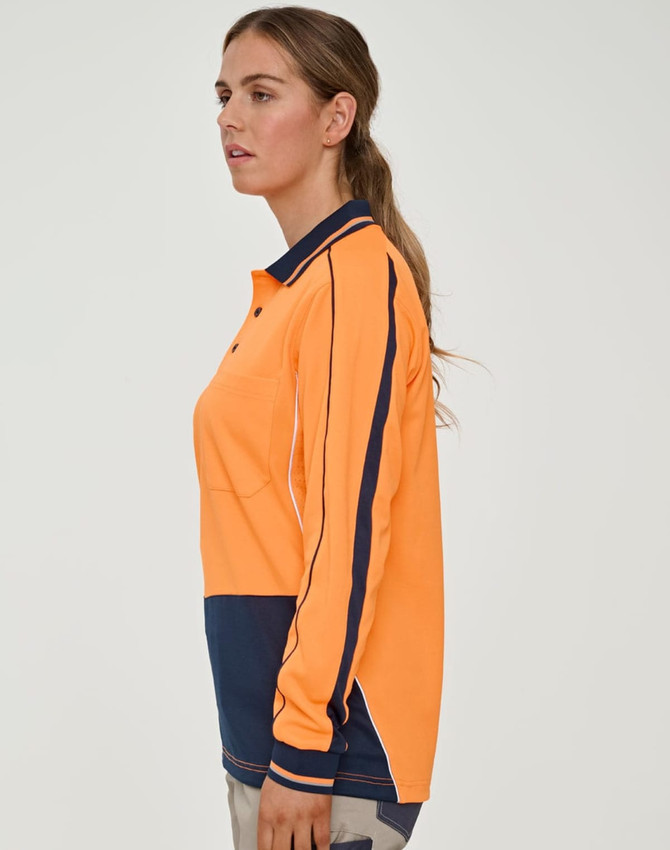 A woman models a bright orange long-sleeve polo shirt with navy accents and a logo.