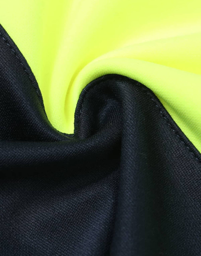 A close-up of a fabric featuring fluorescent yellow and navy blue sections, with a smooth texture and a logo.