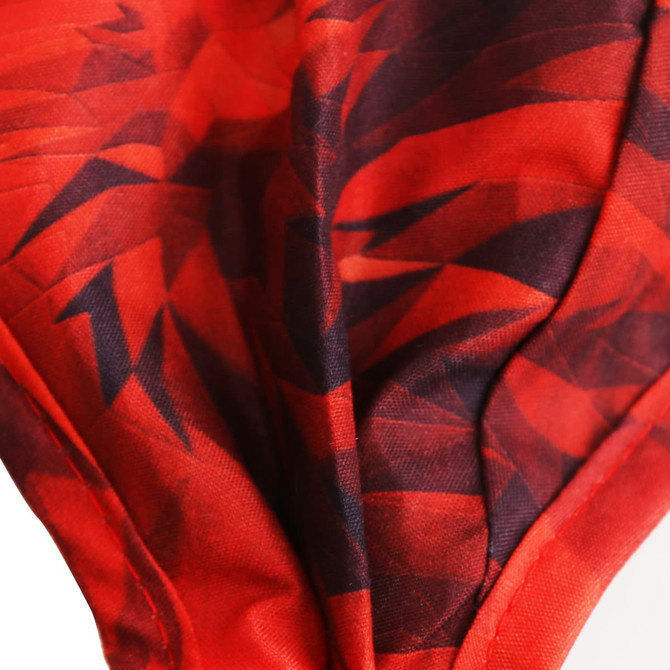 A reusable face mask in vibrant red with a geometric pattern and a logo. Available in adult and children's sizes.