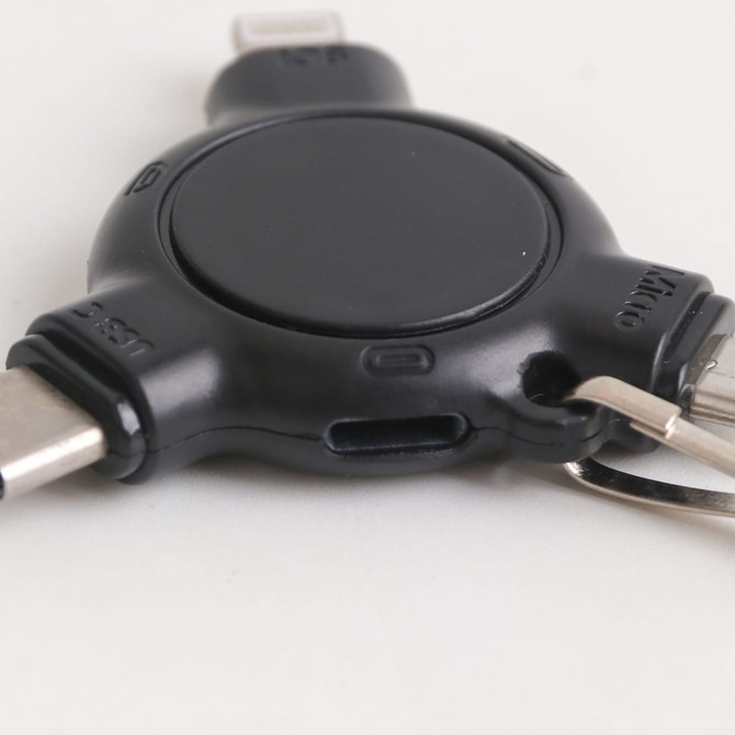A black 3-In-1 ABS data blocker with a keyring and three different charging connectors attached.