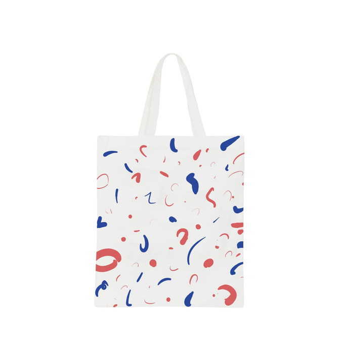 A cotton bag features a white background with colourful abstract shapes in red and blue, and short handles. A cotton bag features a white background with colourful abstract shapes in red and blue, and short handles.
