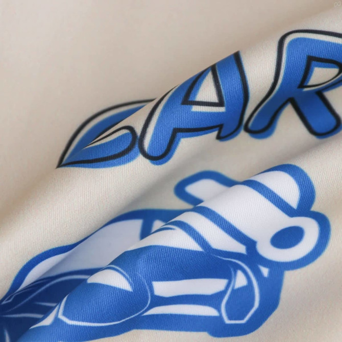 A polyester fabric featuring cream and blue colours with a logo and graphic design.