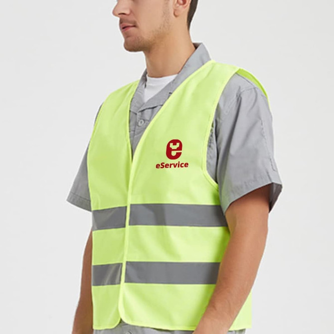 A high-visibility yellow vest with horizontal reflective tape, featuring a logo on the front.