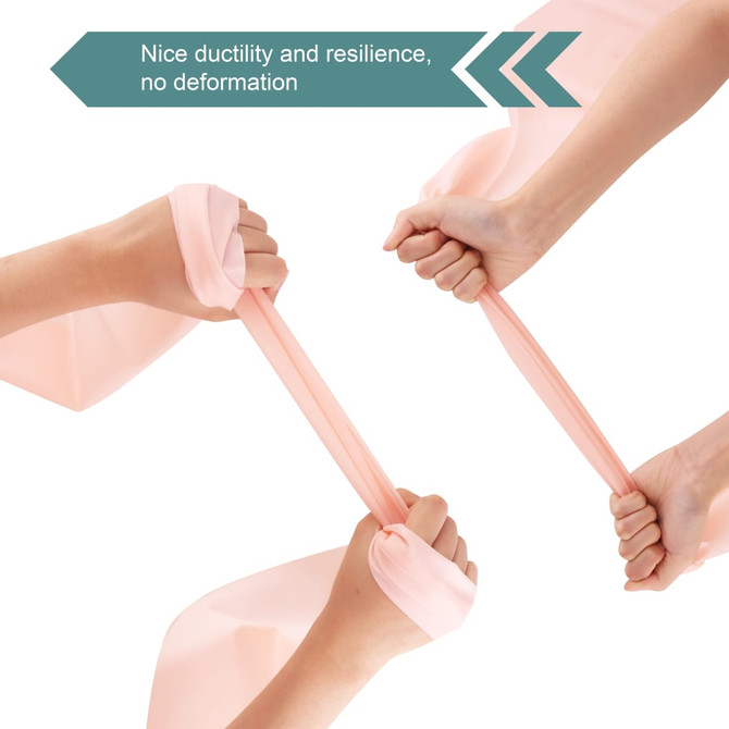 A fitness resistance band in a soft pink hue, featuring hands demonstrating its elasticity and strength.