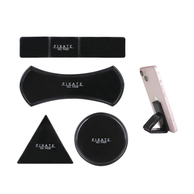 A set of black sticky nano rubber pads in various shapes, including a circle, triangle, rectangle, and curved form, with a phone resting on one.