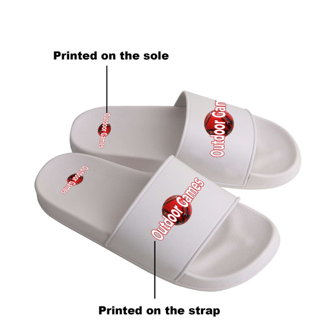 White PVC slides with printed designs on the strap and sole, featuring branding elements.