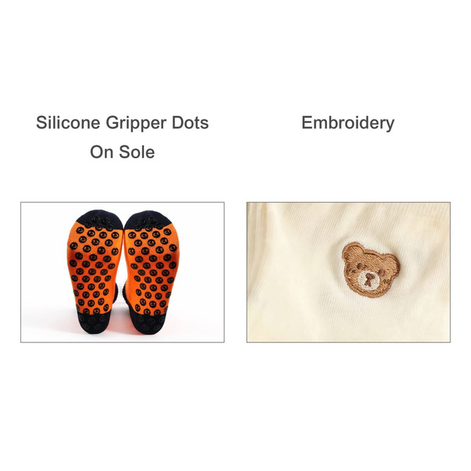 A pair of woven socks featuring orange silicone gripper dots on the sole and embroidered bear design.