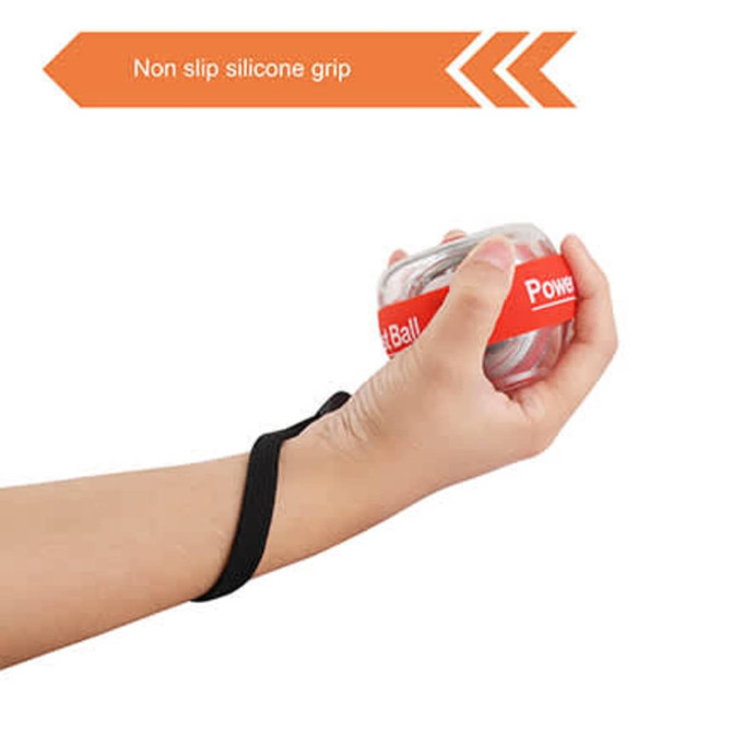 A clear wrist ball with a red band and a black non-slip silicone grip, held in a person's hand.