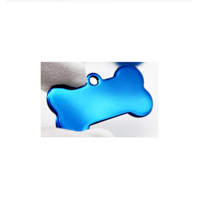 A blue bone-shaped pet ID tag being held by two fingers, featuring a hole for attachment.