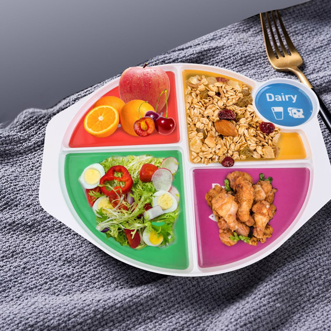 A melamine portion plate featuring divided sections with colourful foods including fruits, salad, oats, and chicken. 