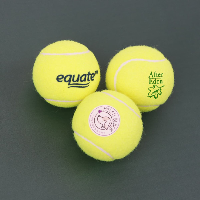 Three bright yellow tennis balls, each featuring a different logo or branding.