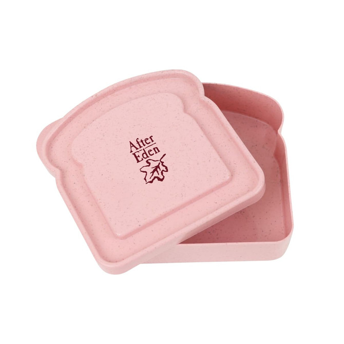 A pink portable bamboo fibre lunch box shaped like a slice of bread, with an embossed logo inside.