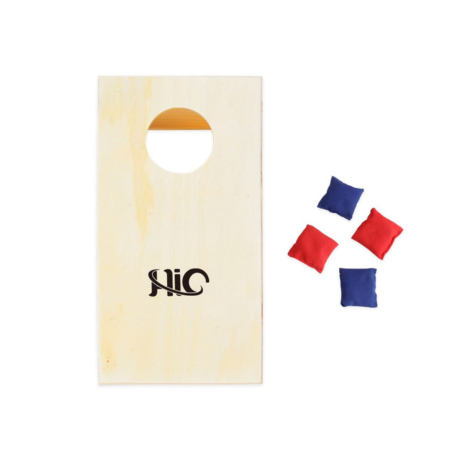 A mini cornhole game board in natural wood with a hole, accompanied by four bean bags in blue and red.