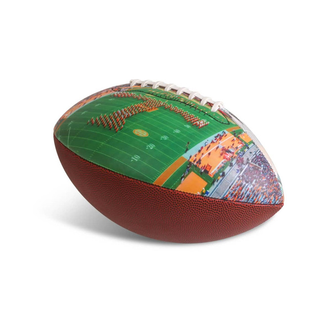 A promotional American football with a textured brown surface and vibrant printed graphics of a sports field.