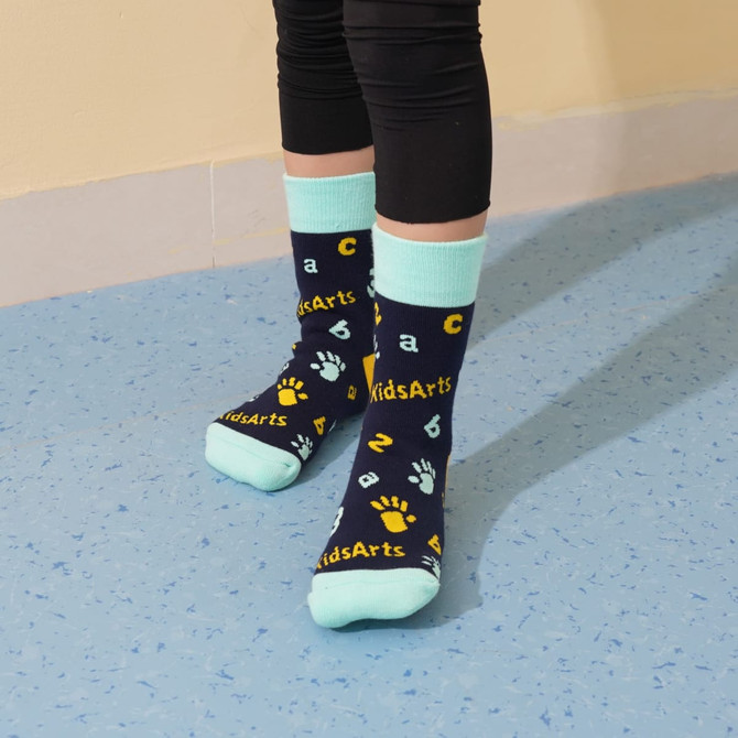 Crew Kids Thermal socks in navy blue with light blue accents, featuring colourful patterns and a logo.